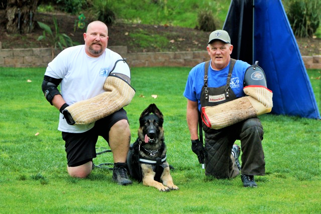 Kapital K9 owners with a German Shepherd at a training session